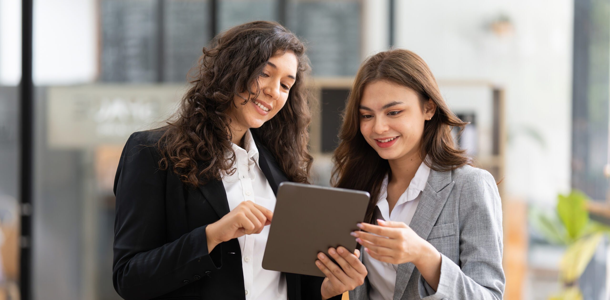 Two business women looking at an iPad