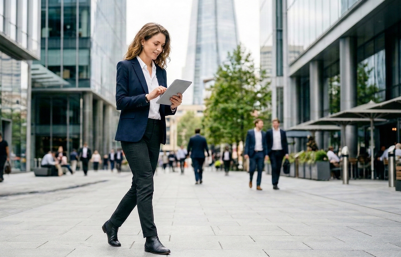 Woman executive walking and looking at a tablet, choosing a pharma crm